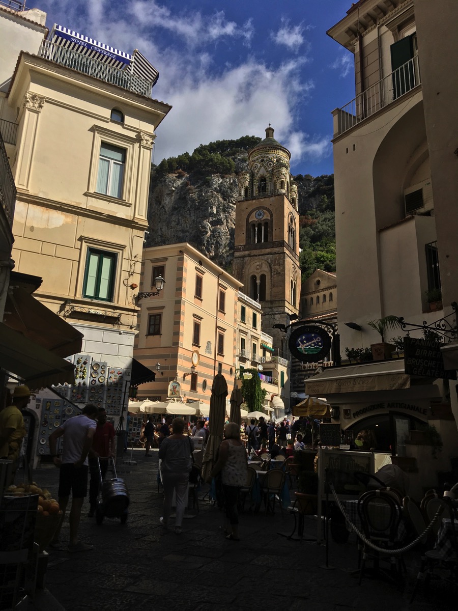 Me walking down some stairs in a built up town 