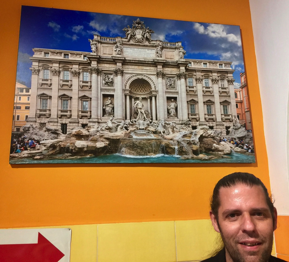 my face in the bottom right corner and a colourful sign with the old building on