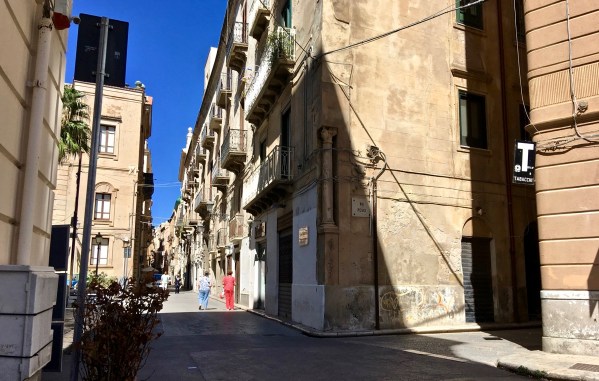 Narrow road with building either side really tall