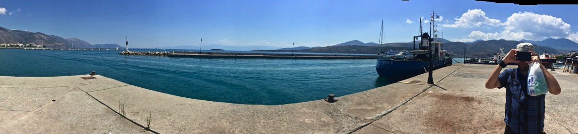 panorama of the whole dock with the sea in the middle and i am over on the right taking a photo with my phone of Sarah