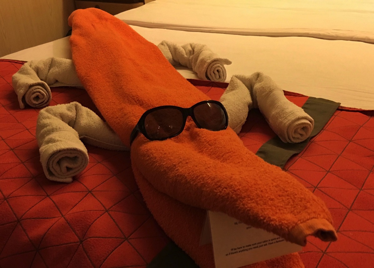 photo of a towel creature lay on the bed