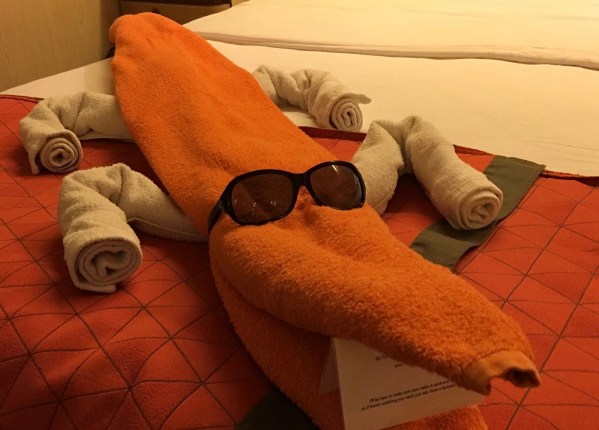photo of a towel creature lay on the bed