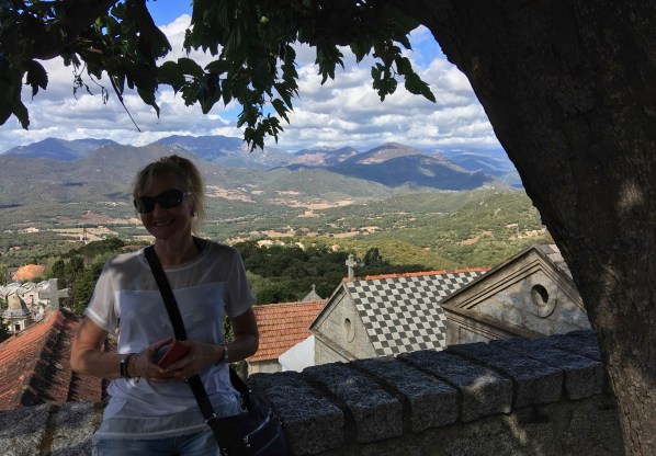 Photo of Sarah under a tree with the Corsica hills in the background