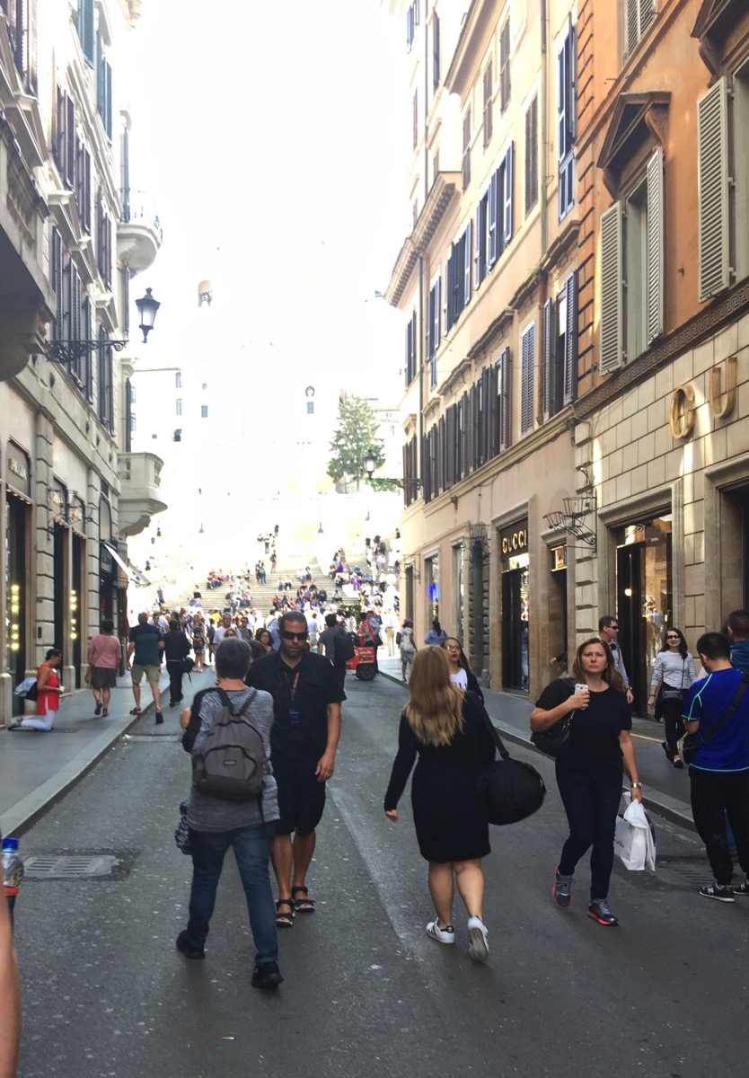 Really busy lane with lots of tall buildings all around