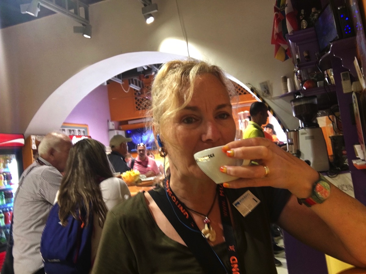 Sarah drinking a coffee at a cafe/restaurant outside