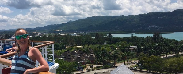 Sarah on the deck with the beautiful Jamaican background behind her