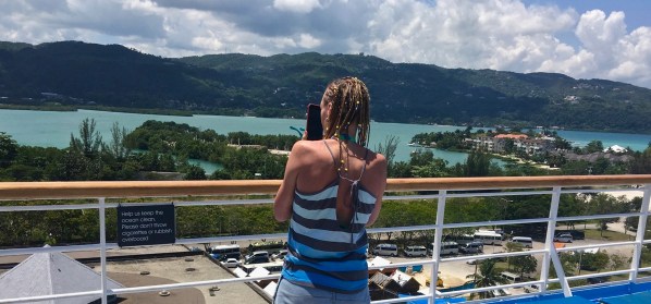 Sarah on the deck with the beautiful Jamaican background behind her