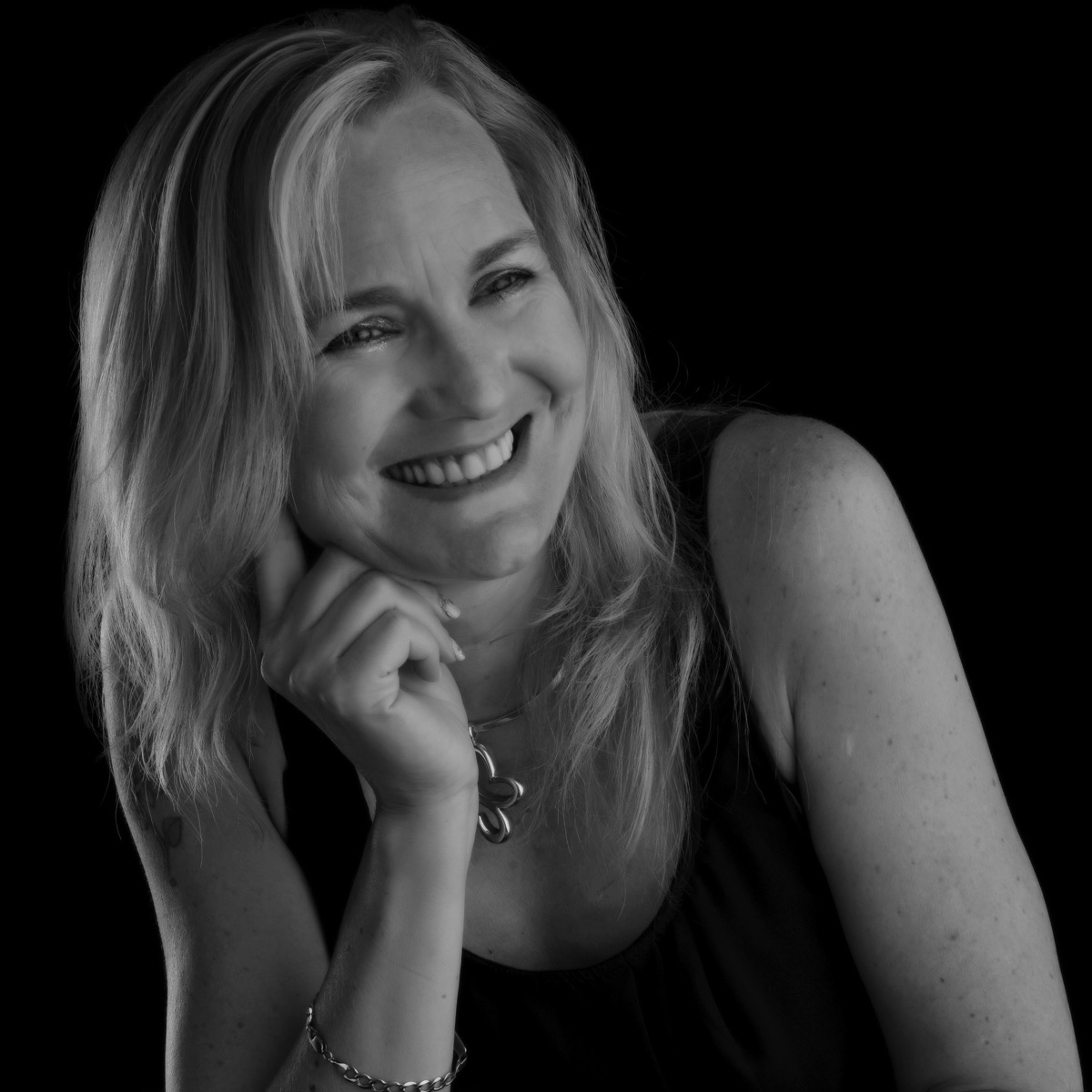 Sarah resting on her hand in a portrait