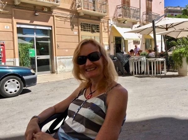 Sarah sat down with the stunning buildings behind her