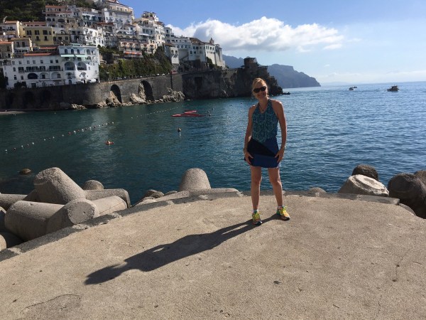 Sarah stood on the edge of the small dock with sea all around her and mountains in the background
