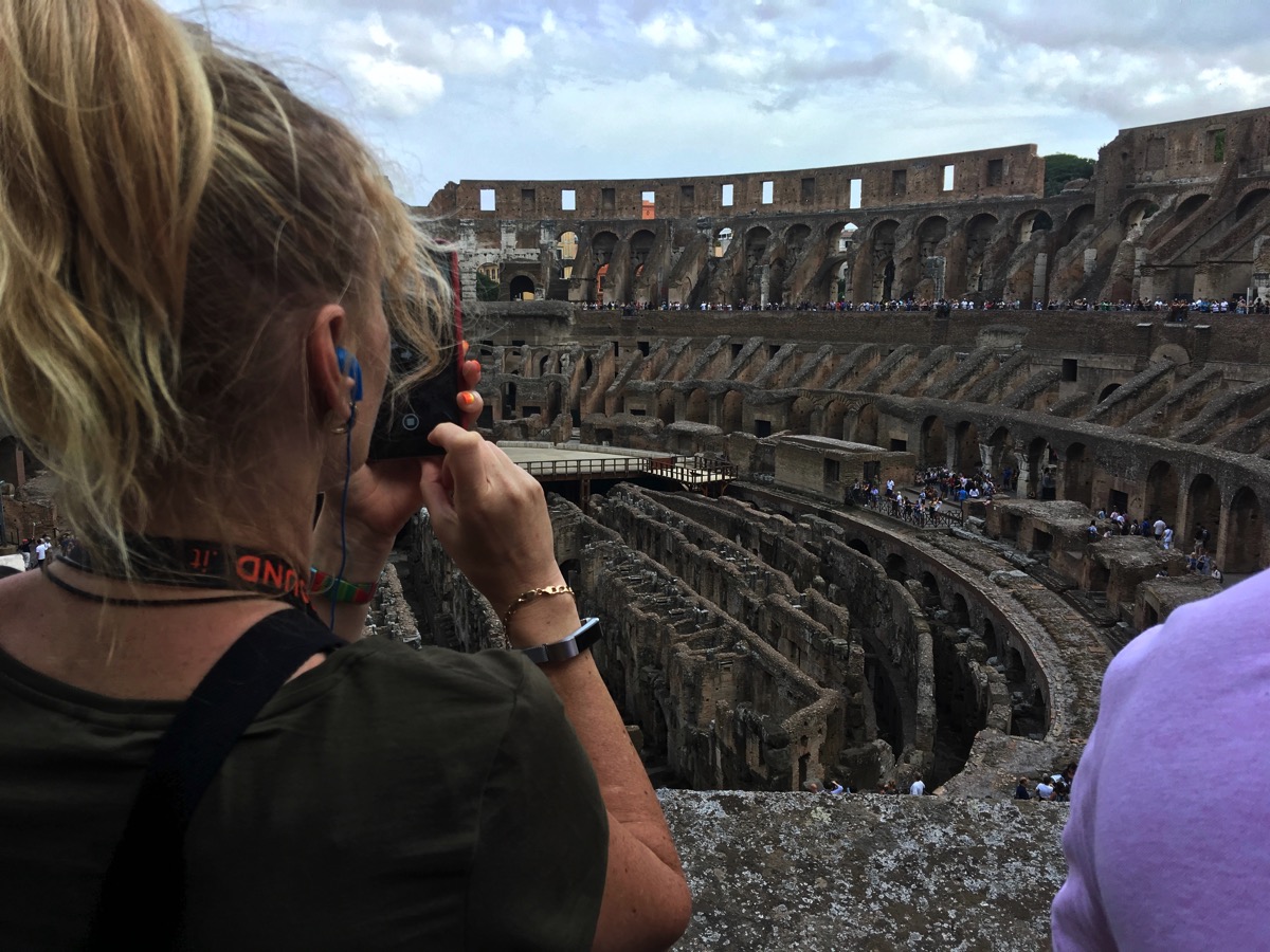 Sarah taking a photo over looking the iside of the Colosseum
