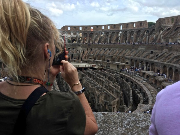 Sarah taking a photo over looking the iside of the Colosseum