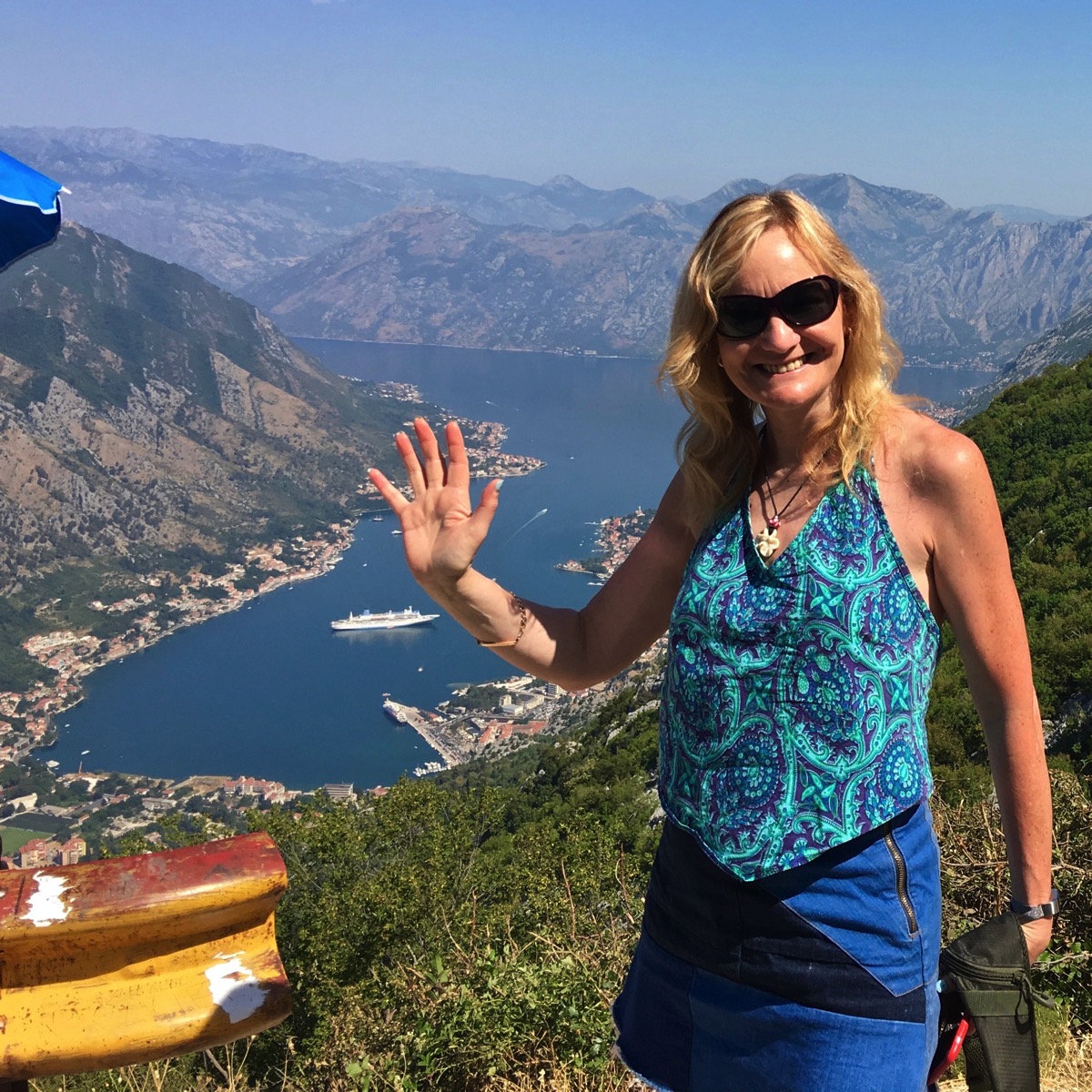 Sarah waving stood in front of the ship right down in th bottom of the valley