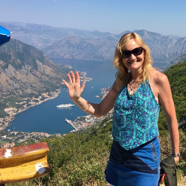 Sarah waving stood in front of the ship right down in th bottom of the valley