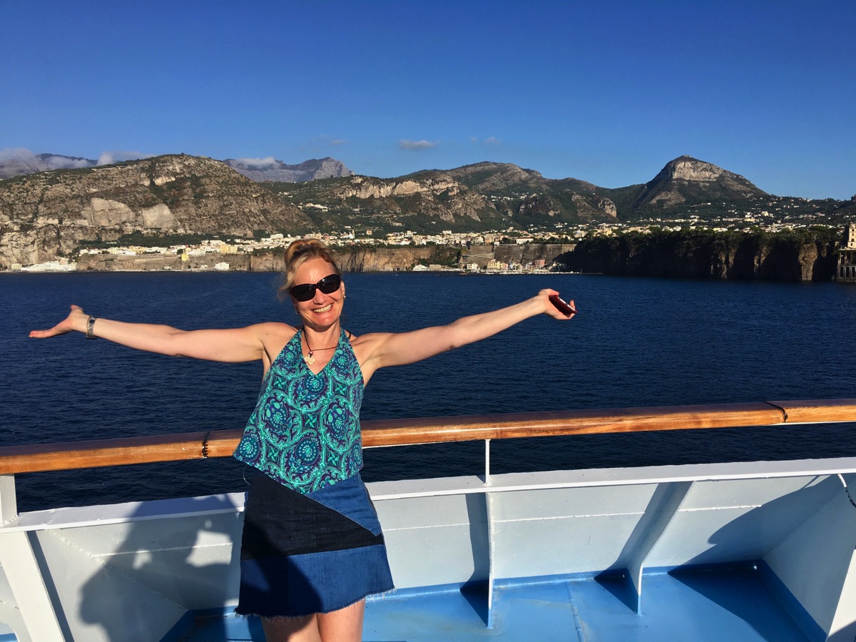 Sarah with arms out stretched welcoming you to Sorrento