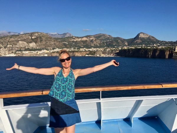Sarah with arms out stretched welcoming you to Sorrento