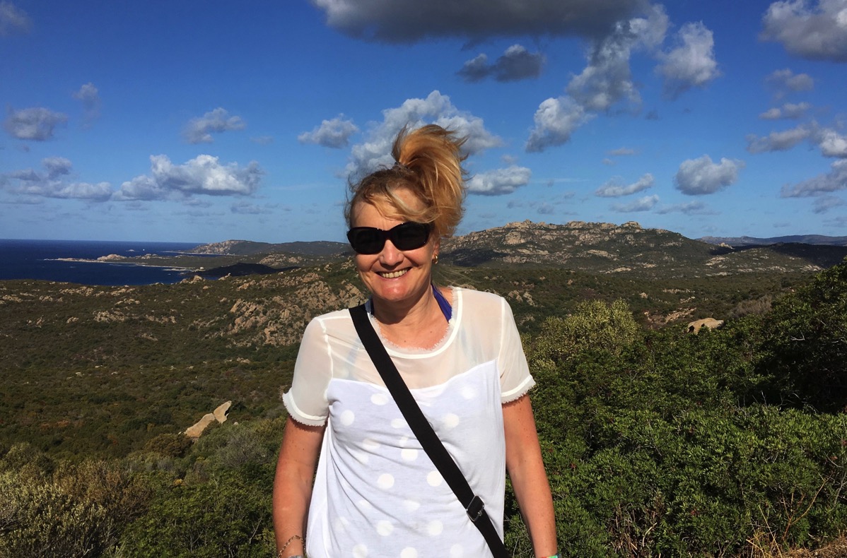 Sarah on a sunny day with the Corsican coast behind her