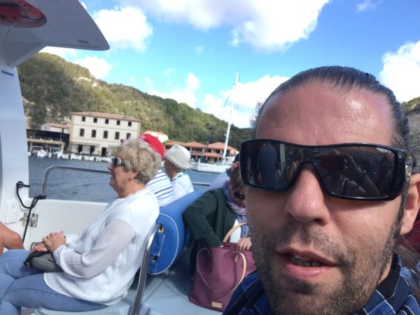 Selfie of me (bottom right) on the boat with the mountains behind 