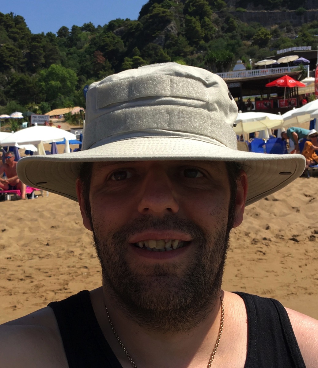 selphie of me in my tactical sun hat with my face in the shade from my hat but the sun is shining all around