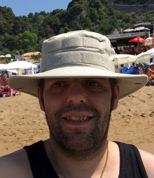 selphie of me in my tactical sun hat with my face in the shade from my hat but the sun is shining all around