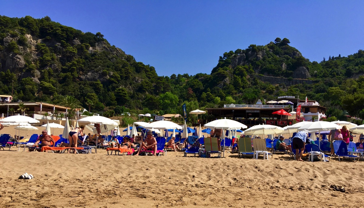 The cafe overlooking the beach with lots of umbrellas outside for shade on the sun beds