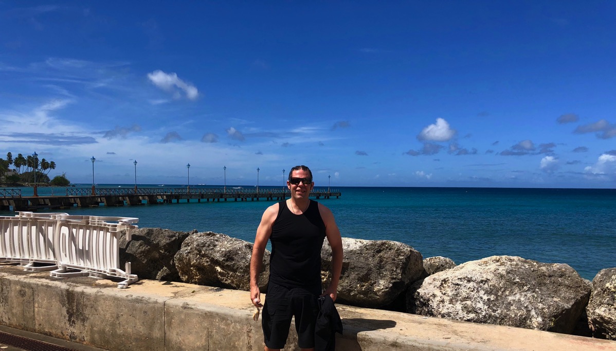 e stood looking towards the camera in front of the sea