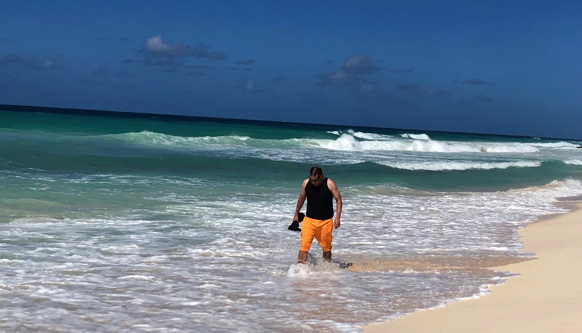 me walking along the beach with my feet in the shllow water