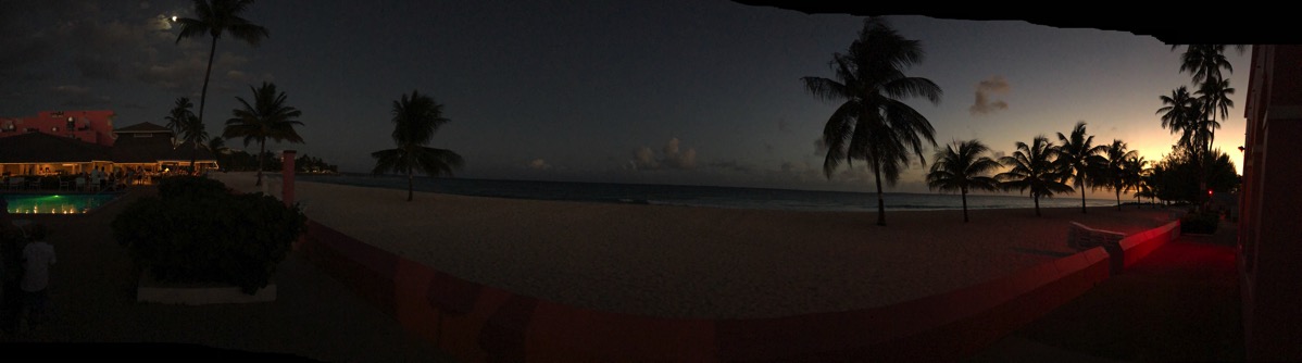 Panorama with a sunet in the far right and the moon on the far left