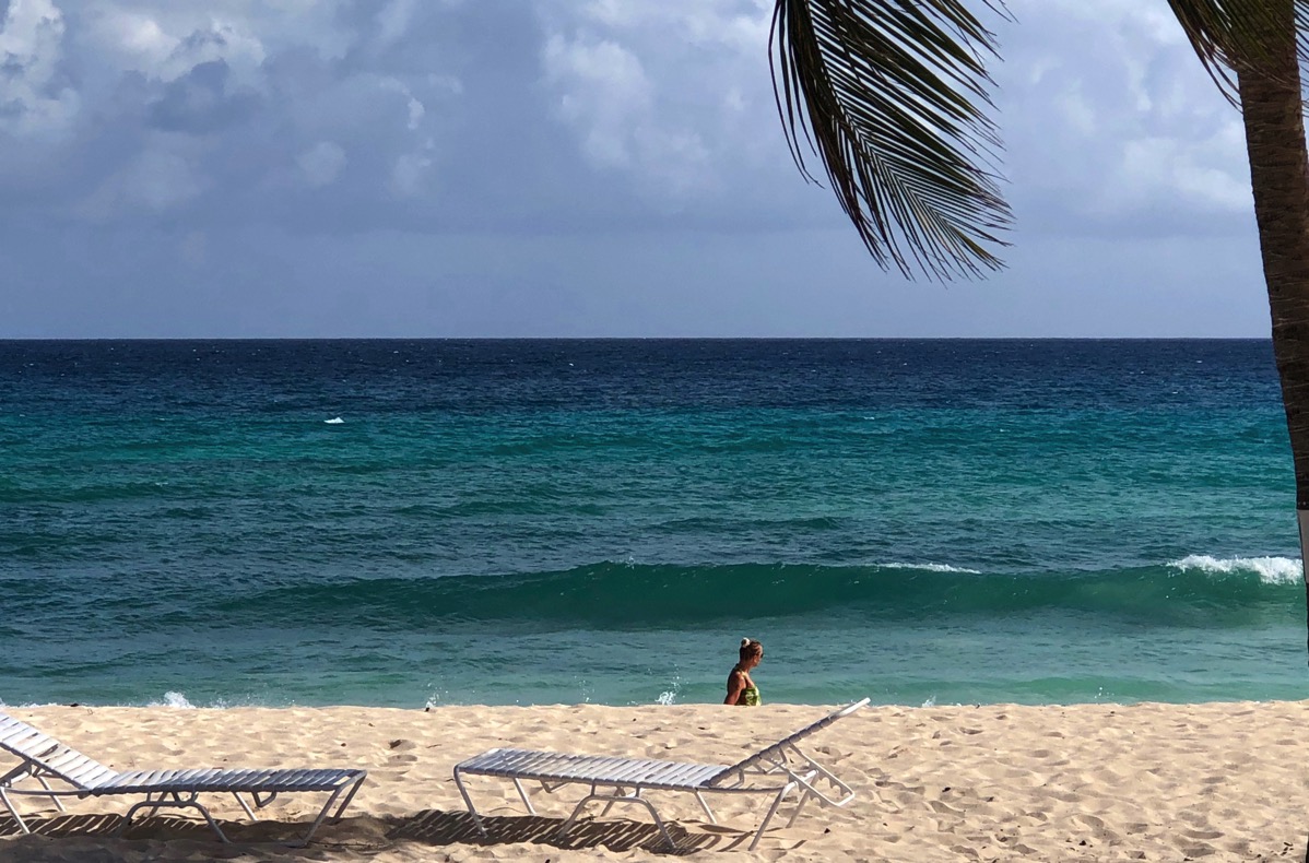 Sarah and the green dress walking on the beach