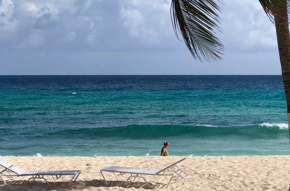 Sarah and the green dress walking on the beach