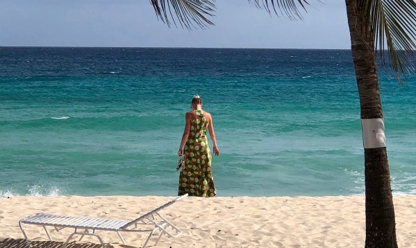 Sarah and the green dress walking on the beach