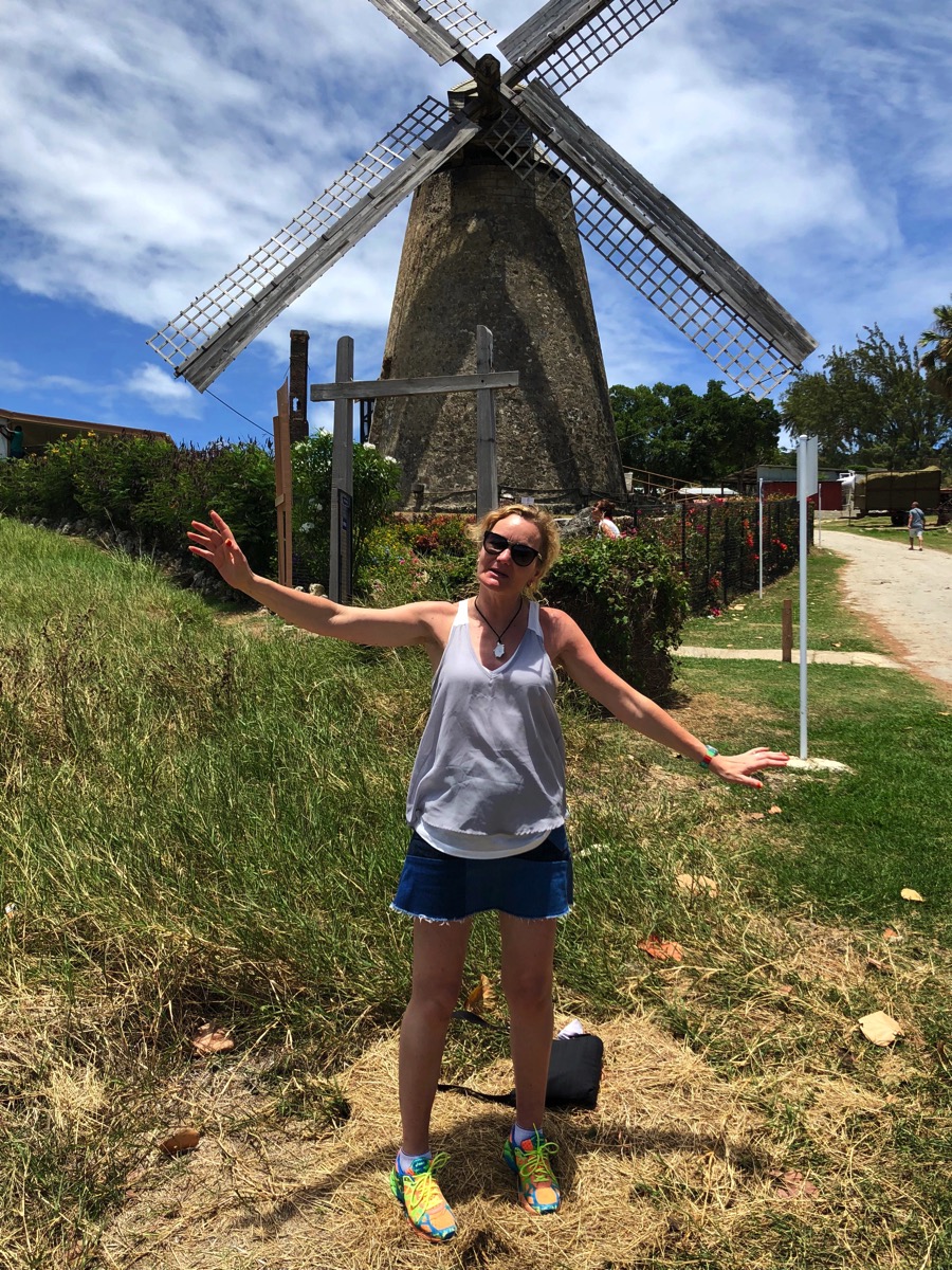Sarah stood in front of the windmill moving her arms to the sails of the windmill