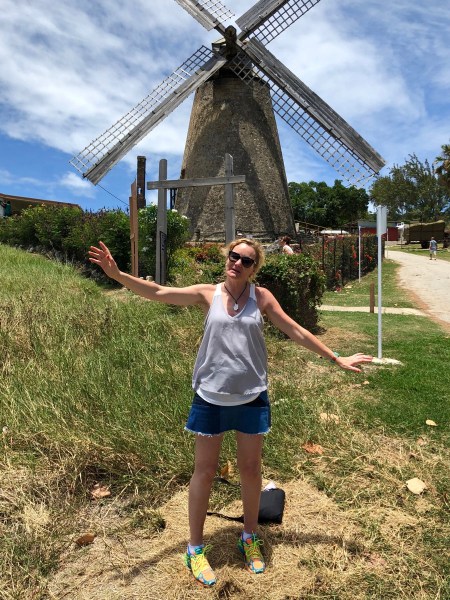 Sarah stood in front of the windmill moving her arms to the sails of the windmill