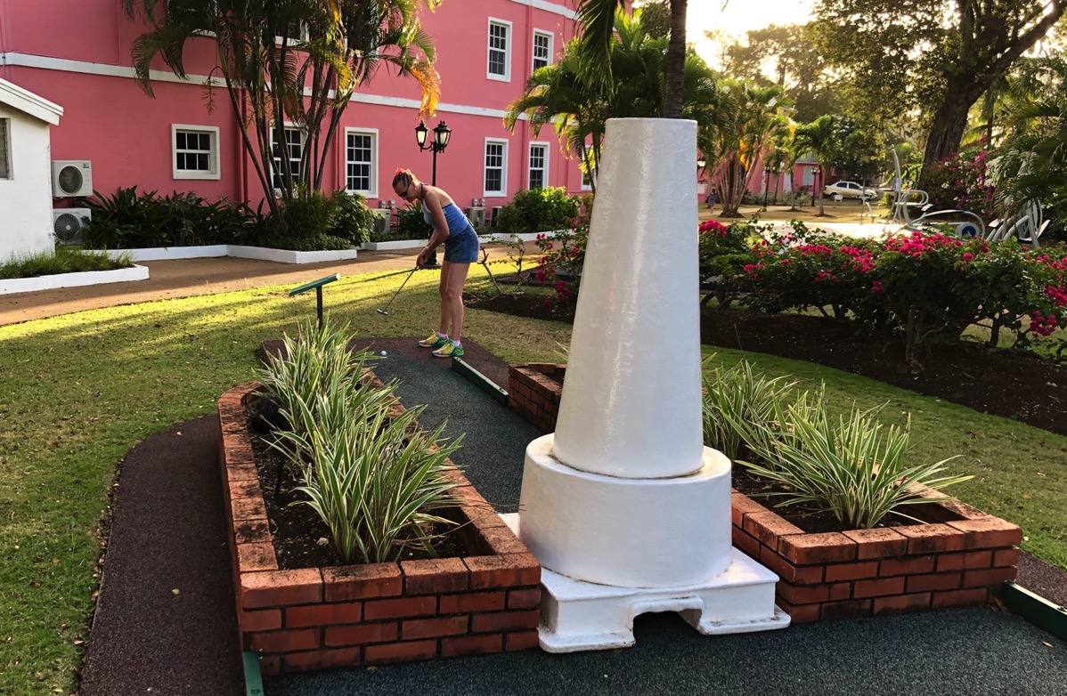 Sarah taking a shot on a lighhouse crazy golf course at Southern palms in Barbados