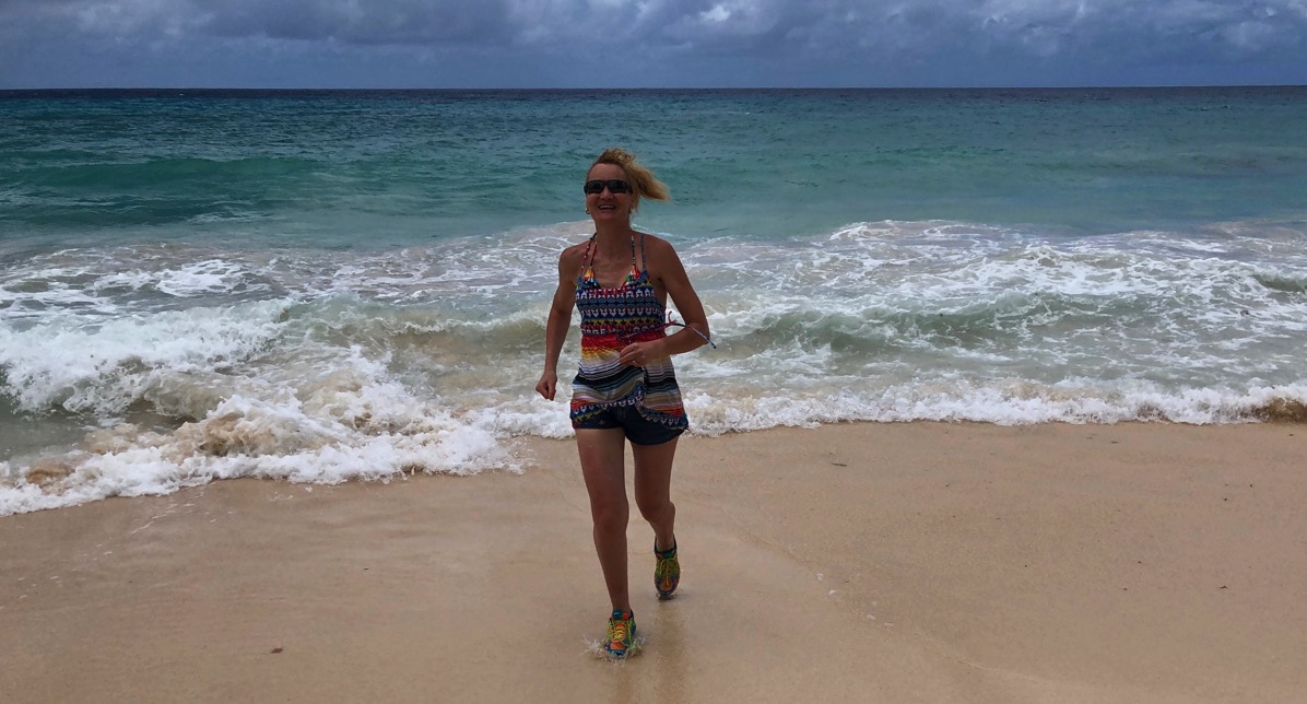 Sarah running on Barbados beach