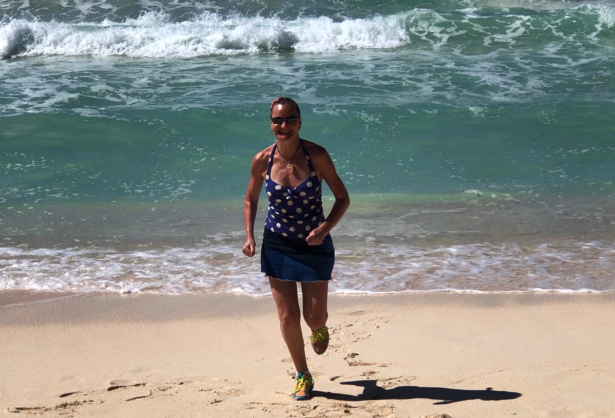 Sarah running on the beach directly towards us