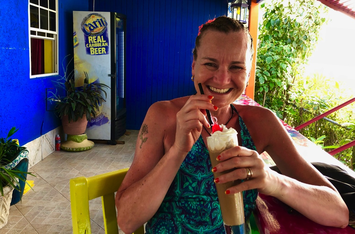 Sarah sat with an iced coffee in the very colourful Sharkey's Tropical Cafe