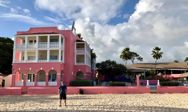 Southern palms hotel from the beach with palm trees and me in the front