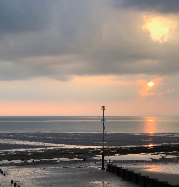 sunset looking out over the beach and the breakers